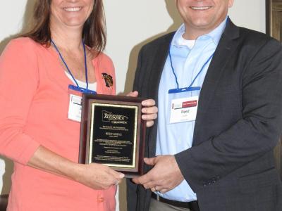 Julie Anderson presents Mathiowetz Award to Reed Leidle